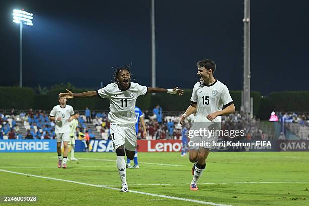 Wisdom Mike of Germany celebrates scoring his team's third goal during the first stage Group G match between El Salvador and Germany at Aspire Zone...