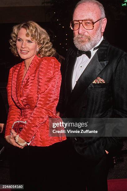 American actress Sharon Gless, wearing a red jacket, and her husband, American television producer Barney Rosenzweig, who wears a tuxedo and bow tie,...
