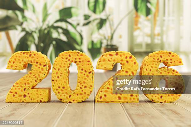 2026 with tortilla texture on wood, indoor plants - tortilla de patata fotografías e imágenes de stock