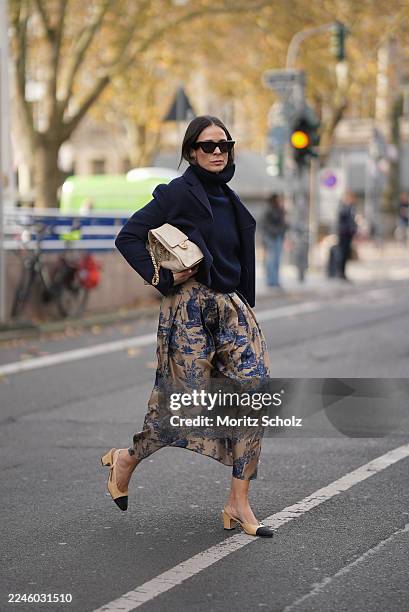 Duesseldorf, GERMANY Patricia Wirschke is seen wearing a navy cropped wool jacket with structured shoulders and a boxy silhouette by Odeeh; a navy...