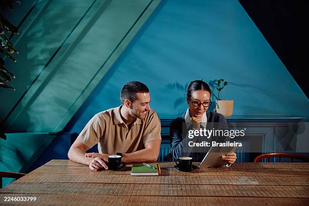 kollegen, die in der kaffeepause am tablet zusammenarbeiten - die neue normalität stock-fotos und bilder
