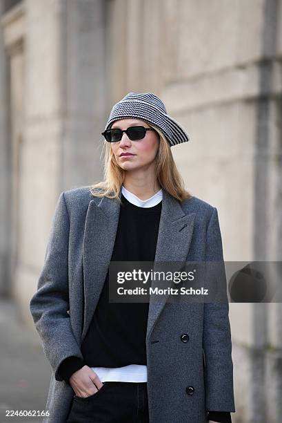 Duesseldorf, GERMANY Laura Schulte is seen wearing a long double-breasted wool coat in grey with structured shoulders and a tailored silhouette by...