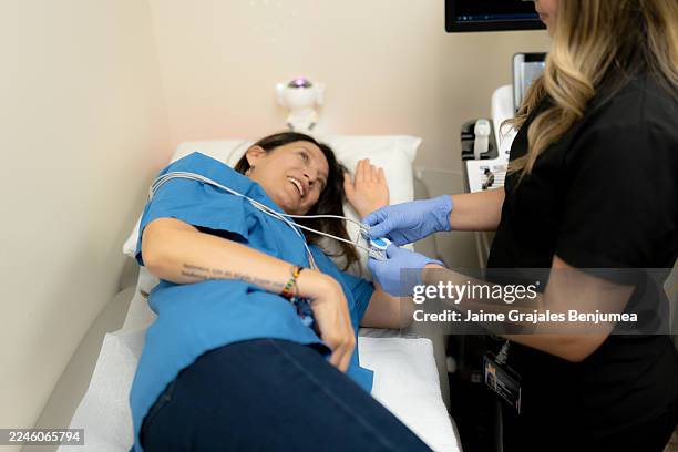 mediziner bringt patientenmonitor während der herzuntersuchung an - echokardiogramm stock-fotos und bilder