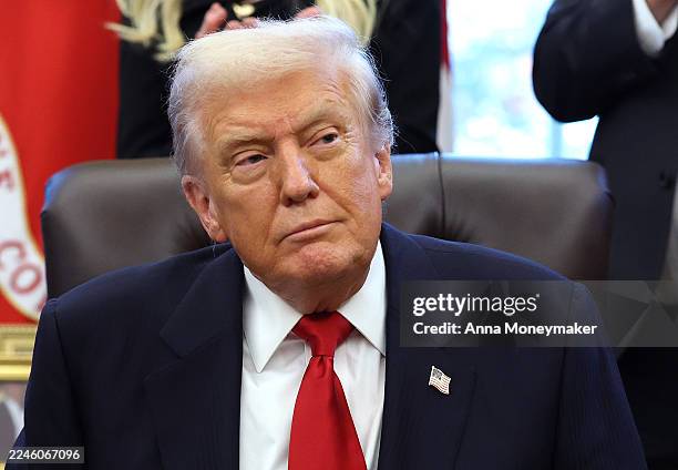 President Donald Trump looks on during the swearing-in ceremony of U.S. Ambassador to India Sergio Gor in the Oval Office of the White House on...