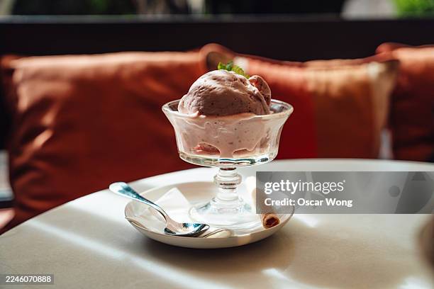 closeup of chocolate ice cream served in a sundae cup at a restaurant. - gelato stock pictures, royalty-free photos & images