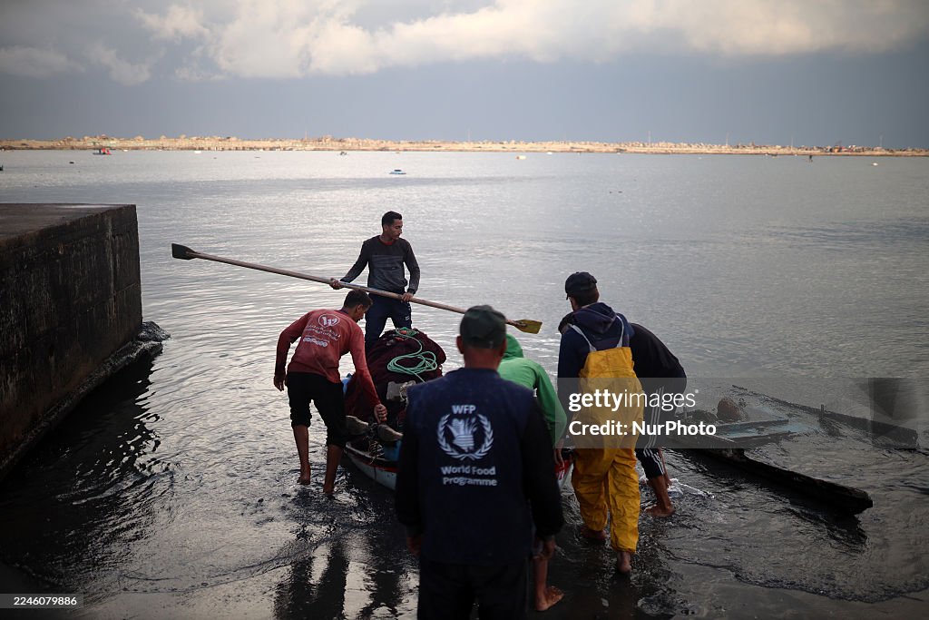 Alestinian Fishermen Row Their Boats In Gaza City Port