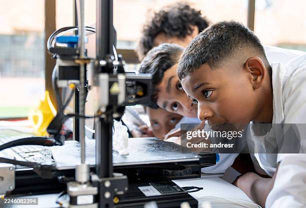 group of young students printing a 3d object in class at the school - 3d printing stock pictures, royalty-free photos & images