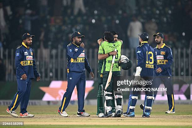 Pakistan's Babar Azam and Mohammad Rizwan celebrate after winning the second one-day international cricket match between Pakistan and Sri Lanka at...