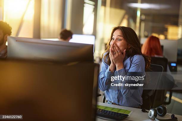 surprised female programmer working on desktop pc in the office. - programmer computer stock pictures, royalty-free photos & images
