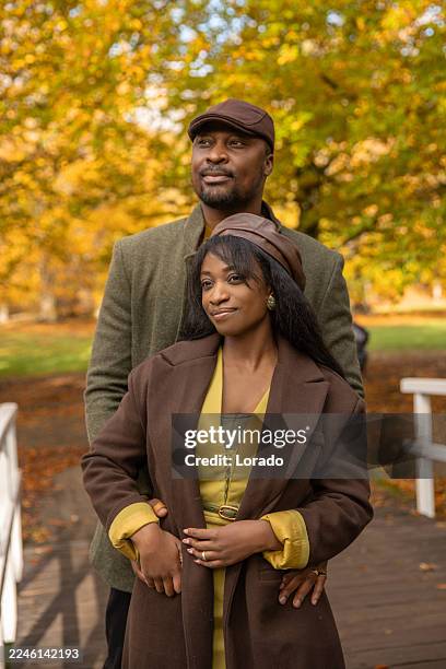 beautiful black couple enjoying an autumn walk in the park - modern manhood stock pictures, royalty-free photos & images
