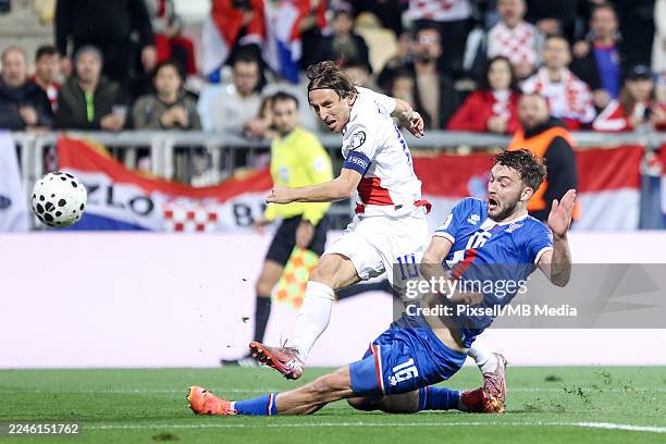 Luka Modric of Croatia shoots whilst under pressure from Gunnar Vatnhamar of Faroe Islands during the FIFA World Cup 2026 qualifier match between...