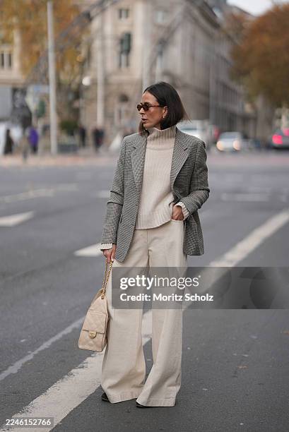 Duesseldorf, GERMANY Patricia Wirschke is seen wearing a beige turtleneck cashmere sweater with a wide collar by Soft Goat; high-waisted wide-leg...