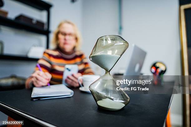 time passing in therapy session - hourglass stock pictures, royalty-free photos & images