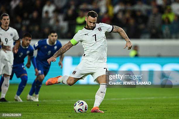 Austria's forward Marko Arnautovic shoots a penalty kick and scores his team's first goal during the FIFA World Cup 2026 European qualification...