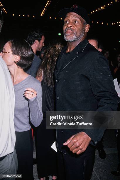 American actor Danny Glover, wearing a black blazer and a black baseball cap, attends the Century City premiere of 'For the Love of the Game' at the...
