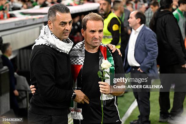 Palestine's coach Ehab Abu Jazar presents a rose and the traditional Palestinian scarf Keffiyeh to Basque Country's head coach Jagoba Arrasate before...