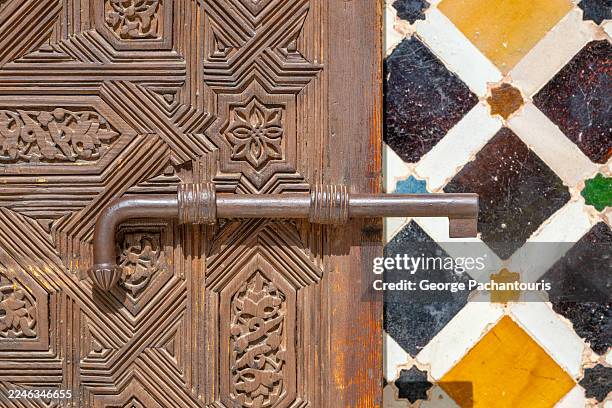 ornate wooden door with metal handle - alhambra stock-fotos und bilder