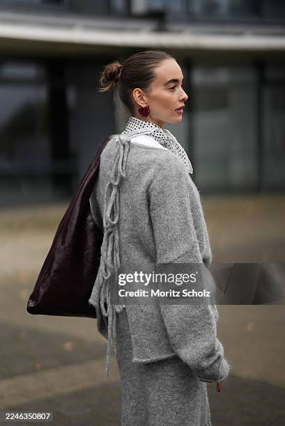 Evi Wave is seen wearing an oversized boatneck grey pullover by Aylin Koenig x Anita Hass with a slouchy fit, dropped shoulders and elongated sleeves...
