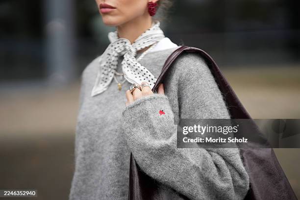 Evi Wave is seen wearing an oversized boatneck grey pullover by Aylin Koenig x Anita Hass with a slouchy fit, dropped shoulders and elongated sleeves...
