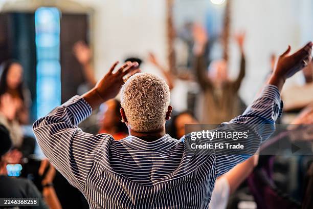 rear view of a worshipper celebrating on a church - religious event stock pictures, royalty-free photos & images