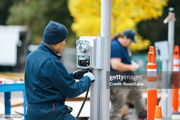 electric vehicle charging station installation - battery charger stock pictures, royalty-free photos & images