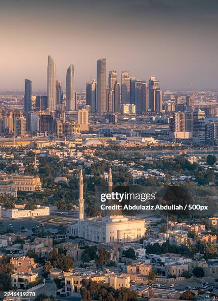 aerial view of a modern cityscape featuring towering skyscrapers and a traditional mosque under a clear sky,dubai,united arab emirates - moské bildbanksfoton och bilder