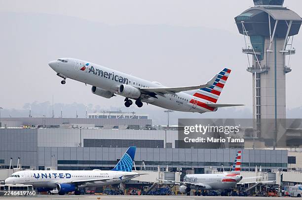 An American Airlines plane takes off near the air traffic control tower at Los Angeles International Airport on November 12, 2025 in Los Angeles,...