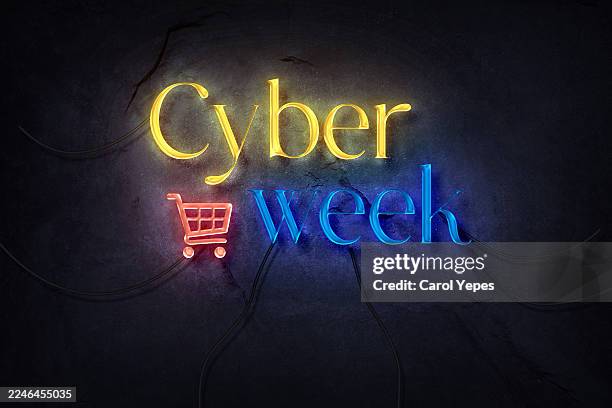 neon light sign advertising "cyber week" mounted on a dark, textured stone or concrete wall. - week stock pictures, royalty-free photos & images