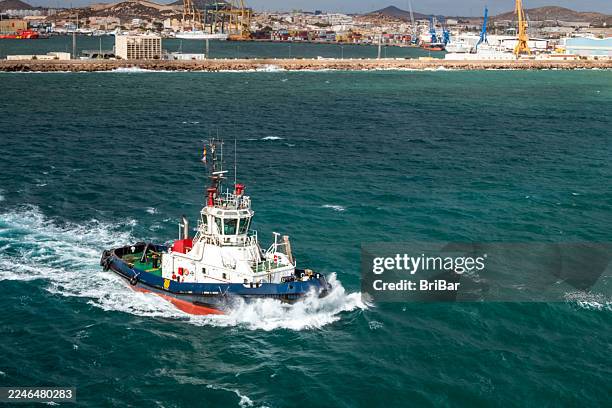 tugboat moving at speed escorting a cruise ship out of the harbour - seascape stock pictures, royalty-free photos & images