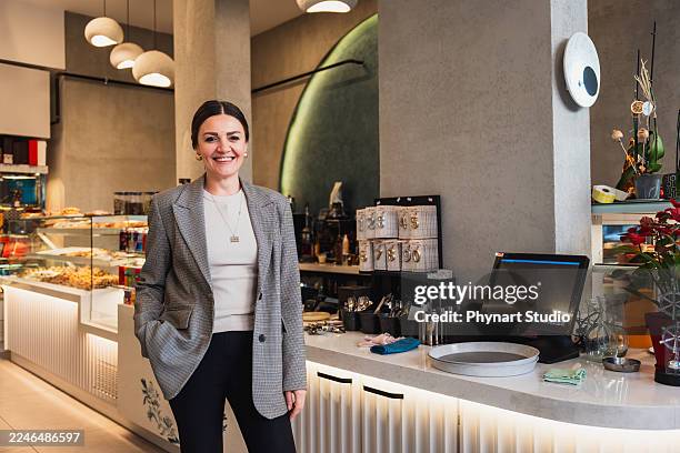 confident cafe owner standing inside modern coffee shop - flatten the curve stock pictures, royalty-free photos & images