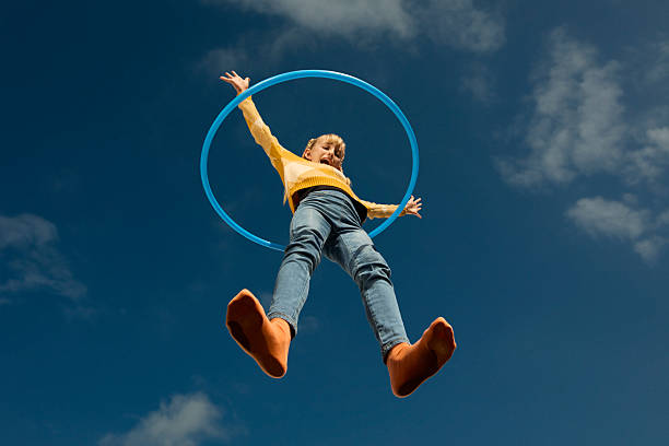 girl spinning hula hoop on glass surface - round character stock pictures, royalty-free photos & images