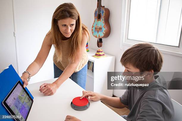 neurodivergent boy during a music therapy session - assistive technology stock pictures, royalty-free photos & images