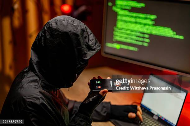 hacker holding phone with unknown call phishing for data - scammer stock pictures, royalty-free photos & images