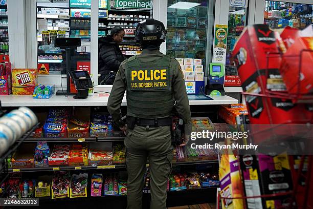 Border Patrol agent talks with a gas station worker on November 17, 2025 in Charlotte, North Carolina. Federal agents are carrying out "Operation...