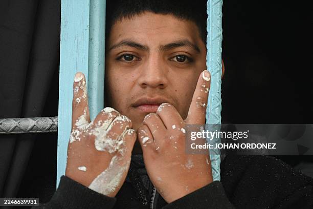 Mara Salvatrucha gang member makes a gang sign during a raid in Pavoncito Prison in Fraijanes, Guatemala on November 17, 2025. The operation is part...