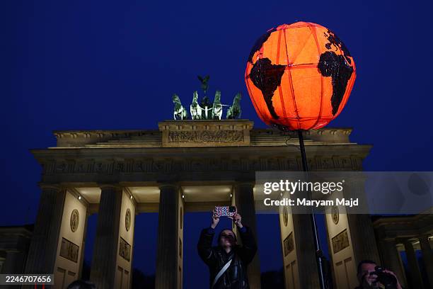 Climate activists of the Fridays for Future movement gather at the Brandenburg Gate to demand that Chancellor Friedrich Merz do more to ensure...