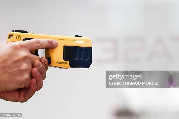 Visitor handles a TASER 10 energy weapon produced by weapon manufacturer Axon during the inauguration of the 24th edition of the global exhibition...