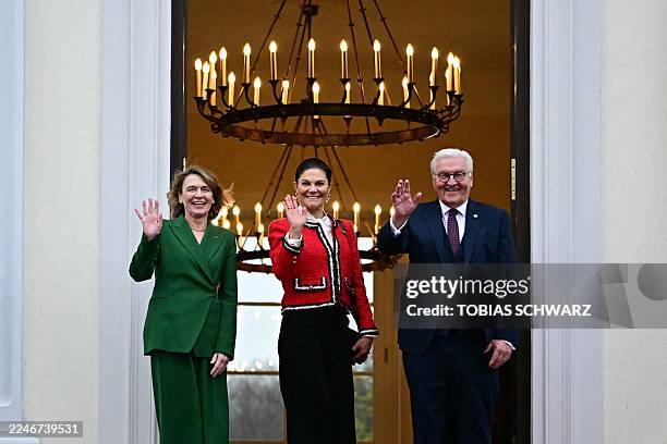 German President Frank-Walter Steinmeier , his wife Elke Buedenbender and Sweden's Crown Princess Victoria make a greeting gesture as they stand by...