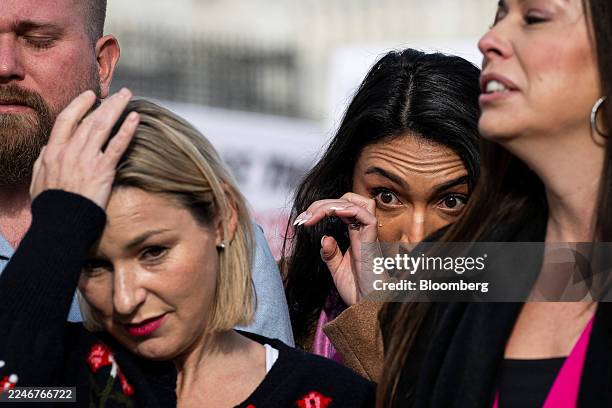Danielle Bensky, a survivor of deceased financier Jeffrey Epstein's sex trafficking ring, center-left, and Amana Roberts, sister-in-law to deceased...
