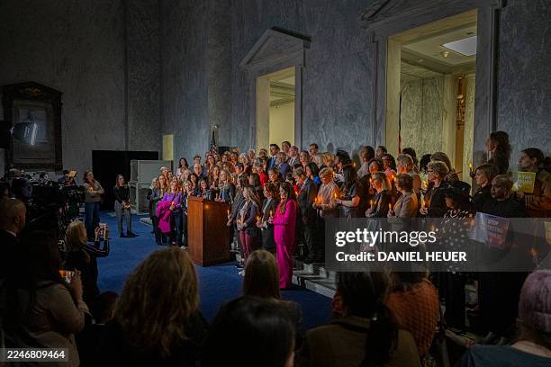 Annie Farmer, victim of convicted sex offender Jeffrey Epstein, speaks from the podium during a candlelight vigil to honor survivors of his crimes in...
