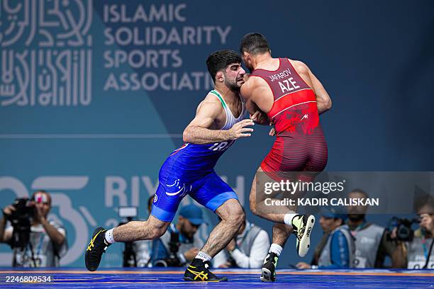 Saeid Esmaeili Leivesi of Iran wrestles against Azerbaijan's Hasrat Jafarov in the men's 67kg Greco-Roman category during the Islamic Solidarity...