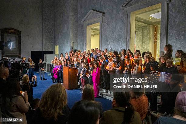 Annie Farmer, victim of convicted sex offender Jeffrey Epstein, speaks from the podium during a candlelight vigil to honor survivors of his crimes in...