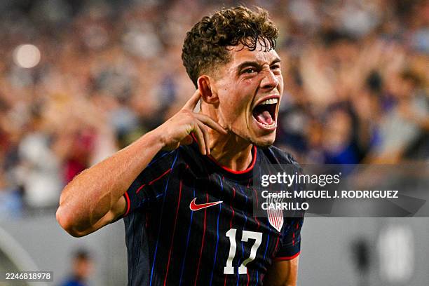 Midfielder Sebastian Berhalter celebrates after scoring his team's first goal during the international friendly football match between USA and...