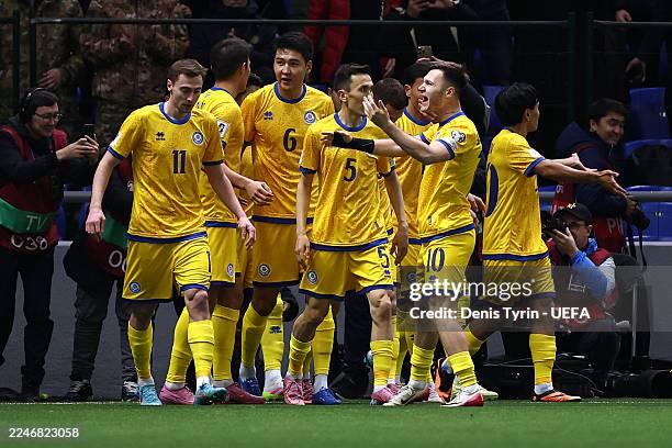 Dastan Satpayev (Hidden of Kazakhstan celebrates scoring his team's first goal with teammates during the FIFA World Cup 2026 qualifier match between...