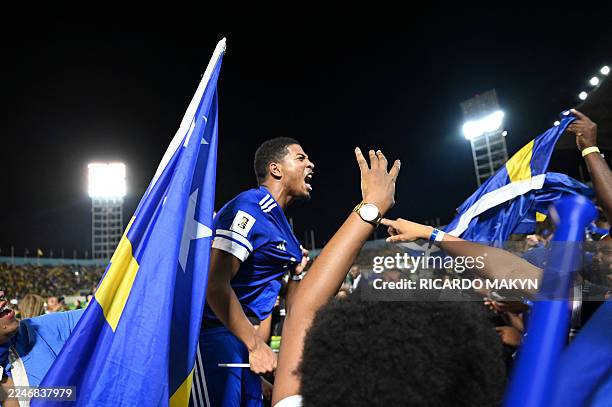 Curaçao players and fans celebrate World Cup 2026 qualification after a 0-0 draw with Jamaica at the National Stadium in Kingston, Jamaica on...