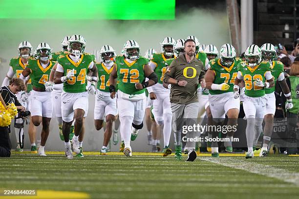 Head coach Dan Lanning of the Oregon Ducks leads his team onto the field prior to the game against the Minnesota Golden Gophers at Autzen Stadium on...