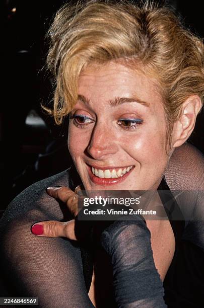 American actress Sean Young, wearing a black outfit with sheer shoulders and sleeves, attends an 'American Foundation for the Performing Arts' Gala...