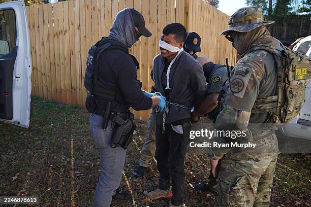 Person is detained by U.S. Border Patrol agents on November 19, 2025 in Charlotte, North Carolina. The man sustained injuries to his face while...