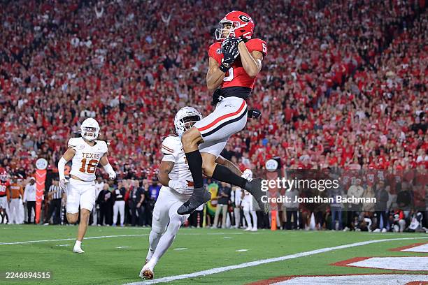 Noah Thomas of the Georgia Bulldogs catches the ball for a touchdown as Jaylon Guilbeau of the Texas Longhorns defends during the first half at...