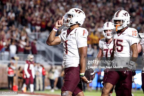 Quarterback Kyron Drones of the Virginia Tech Hokies celebrates after scoring a touchdown during the first half of the game against the Florida State...